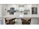 Beautiful kitchen with island, stainless steel appliances, granite countertops, and wooden chairs at 424 N Randolph St, Indianapolis, IN 46201