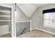 Loft area with a window, closet, and a view of the stairs through the railing at 424 N Randolph St, Indianapolis, IN 46201