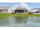 Backyard featuring a serene lake view and lush green lawn at 4258 Hamilton Run, Zionsville, IN 46077