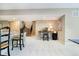 Open basement area with bar seating, a staircase, and designated workspace; ideal for versatile use at 4258 Hamilton Run, Zionsville, IN 46077