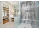 Modern bathroom with glass enclosed shower with rainfall head and marble-look tiles at 4258 Hamilton Run, Zionsville, IN 46077
