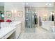 Bright bathroom features soaking tub, double vanity, decorative lighting and glass enclosed shower at 4258 Hamilton Run, Zionsville, IN 46077
