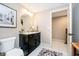Cozy bathroom featuring a granite countertop vanity, round mirror, and tiled floors at 4258 Hamilton Run, Zionsville, IN 46077