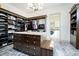 Well-organized walk-in closet with custom shelving, center island and laundry access at 4258 Hamilton Run, Zionsville, IN 46077