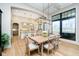 Bright dining room featuring modern light fixture, hardwood flooring, and view to open kitchen at 4258 Hamilton Run, Zionsville, IN 46077