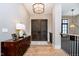 Inviting entryway with hardwood floors, a console table, and a modern chandelier at 4258 Hamilton Run, Zionsville, IN 46077