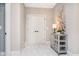 Inviting hallway features double doors, stylish cabinet, and a neutral color scheme at 4258 Hamilton Run, Zionsville, IN 46077