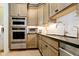 Well-equipped kitchen with stainless steel appliances and neutral-toned cabinetry at 4258 Hamilton Run, Zionsville, IN 46077