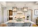Kitchen island with granite counters, stainless appliances and custom lighting at 4258 Hamilton Run, Zionsville, IN 46077