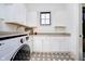 Clean laundry room featuring white cabinetry, modern appliances, and patterned tile flooring at 4258 Hamilton Run, Zionsville, IN 46077