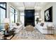 Cozy living room featuring large windows, coffered ceilings, a fireplace, and hardwood flooring at 4258 Hamilton Run, Zionsville, IN 46077