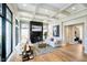 Sunlit living room with a fireplace, modern decor, and hardwood flooring throughout at 4258 Hamilton Run, Zionsville, IN 46077