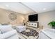 Comfortable living room boasts a plush sofa, decorative rug, entertainment center, and neutral color palette at 4258 Hamilton Run, Zionsville, IN 46077