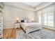 Bright main bedroom features paneled wall, hardwood floors, ceiling fan and large windows at 4258 Hamilton Run, Zionsville, IN 46077