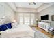 Spacious main bedroom features tray ceiling, hardwood floors and decorative white furniture at 4258 Hamilton Run, Zionsville, IN 46077