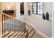 Elegant staircase with carpeted treads, a wooden handrail, and modern black metal balusters at 4258 Hamilton Run, Zionsville, IN 46077