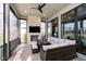 Inviting sunroom with stone fireplace, sectional seating, and screened windows at 4258 Hamilton Run, Zionsville, IN 46077