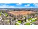 Wide aerial perspective of a residential area with houses, lawns, and abundant trees at 4263 W Fox Ridge Ave, Greenwood, IN 46143