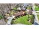 An aerial view of the home showcasing the manicured lawn, brick exterior, and mature trees at 4263 W Fox Ridge Ave, Greenwood, IN 46143