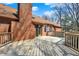 An eye-level shot of the deck highlighting its brick fireplace and entry into the home at 4263 W Fox Ridge Ave, Greenwood, IN 46143