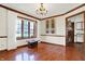 The dining room features a chandelier, hardwood floors, and natural light at 4263 W Fox Ridge Ave, Greenwood, IN 46143