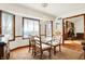Elegant dining room with a glass table, chandelier, and sunlit windows for a refined atmosphere at 4263 W Fox Ridge Ave, Greenwood, IN 46143