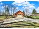 Detached two-car garage featuring a large driveway and well-maintained landscaping at 4263 W Fox Ridge Ave, Greenwood, IN 46143