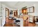 The kitchen features an island with stools, wood cabinets, and hard wood floors at 4263 W Fox Ridge Ave, Greenwood, IN 46143