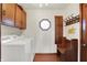 Bright laundry room featuring a washer and dryer with seating, providing a comfortable space at 4263 W Fox Ridge Ave, Greenwood, IN 46143