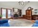 Cozy living room featuring a brick fireplace, vaulted ceilings, wood floors, and french doors at 4263 W Fox Ridge Ave, Greenwood, IN 46143