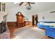 Open living room with wood floors, a brick fireplace, vaulted ceiling, and a cozy blue sectional at 4263 W Fox Ridge Ave, Greenwood, IN 46143