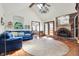 Inviting living room with a brick fireplace, wood floors, and vaulted ceilings for a spacious feel at 4263 W Fox Ridge Ave, Greenwood, IN 46143