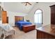 Bright main bedroom features neutral carpet, statement window, and ceiling fan at 4263 W Fox Ridge Ave, Greenwood, IN 46143