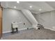 Finished basement with a laundry sink, stairs, utility hookups, and a barn door leading to storage at 4721 Ralston Ave, Indianapolis, IN 46205