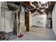 Utility basement featuring modern furnace, water heater, and open storage or work space at 4721 Ralston Ave, Indianapolis, IN 46205