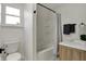 Bright bathroom features a shower and tub combination, a modern vanity and fixtures, and a framed window at 4721 Ralston Ave, Indianapolis, IN 46205