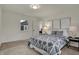 Bright bedroom with carpeted floors, geometric-patterned bedspread, and art deco style wall hangings at 4721 Ralston Ave, Indianapolis, IN 46205