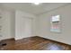 Bedroom features gleaming wood floors, a closet, and a window overlooking the outside at 4721 Ralston Ave, Indianapolis, IN 46205