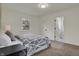 Bright bedroom with carpeted floors, geometric-patterned bedspread, and side-table lamps at 4721 Ralston Ave, Indianapolis, IN 46205