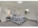 Bright bedroom with carpeted floors, geometric-patterned bedspread, and art deco style wall hangings at 4721 Ralston Ave, Indianapolis, IN 46205