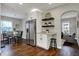 This open concept kitchen has stainless steel appliances, granite countertops, and dark hardwood flooring at 4721 Ralston Ave, Indianapolis, IN 46205