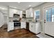 Renovated kitchen with white cabinets, stainless steel appliances, granite countertops, and hardwood floors at 4721 Ralston Ave, Indianapolis, IN 46205