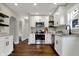 Bright kitchen with white cabinets, stainless steel appliances, granite countertops, and hardwood floors at 4721 Ralston Ave, Indianapolis, IN 46205