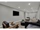 Modern living room with cozy seating, mounted TV, recessed lighting, and neutral color palette at 4721 Ralston Ave, Indianapolis, IN 46205