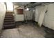 Unfinished basement with stairs and some utilities at 4925 E New York St, Indianapolis, IN 46201