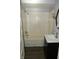 An updated bathroom with a tub, shower, and modern vanity at 4925 E New York St, Indianapolis, IN 46201