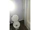 Bathroom featuring a toilet next to a shower and shelving unit at 4925 E New York St, Indianapolis, IN 46201