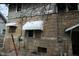 View of the back of the house featuring stone and siding at 4925 E New York St, Indianapolis, IN 46201