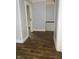 Empty hallway featuring doors, gray walls, and dark wood flooring at 4925 E New York St, Indianapolis, IN 46201