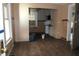 Spacious room with hardwood floors leading to a kitchen with dark countertops at 4925 E New York St, Indianapolis, IN 46201